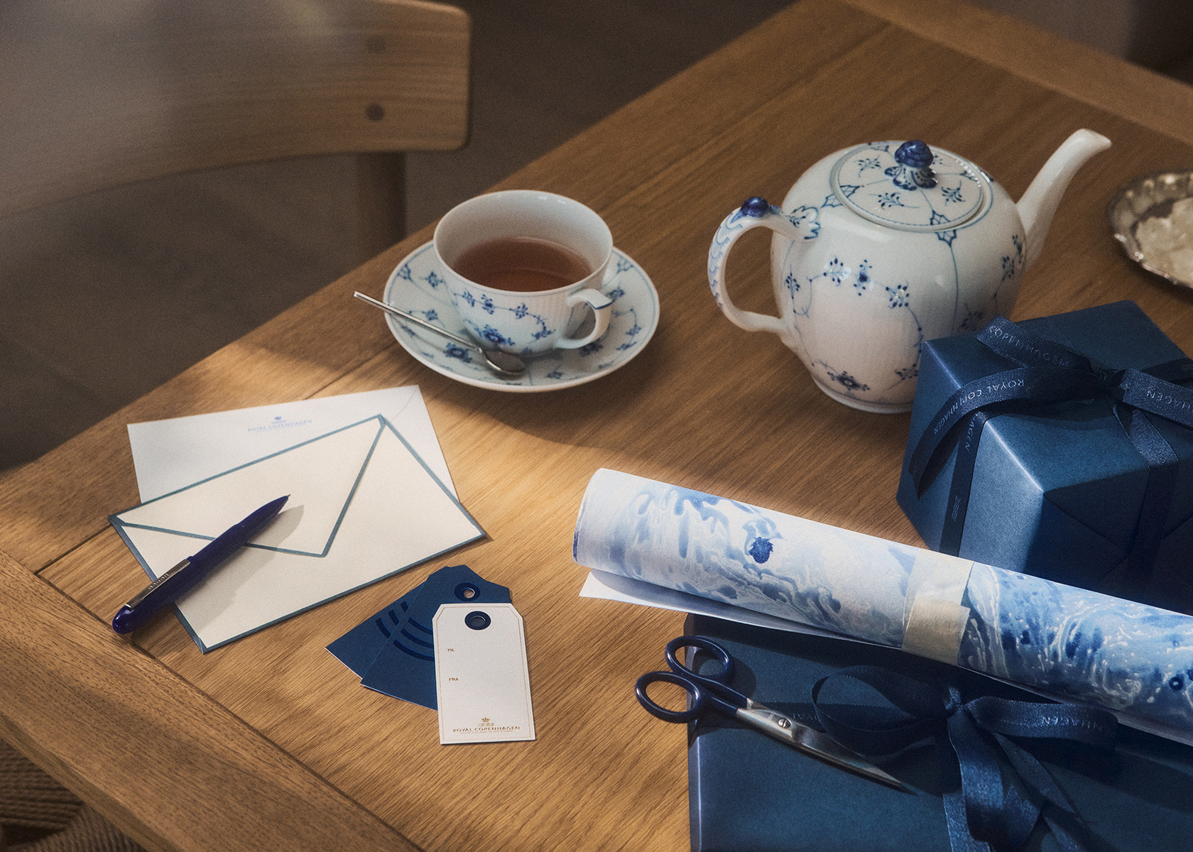 Preparing the gifts while having a cup of tea - teapot and cup and saucer from Royal Copenhagens Blue Fluted Plain collection
